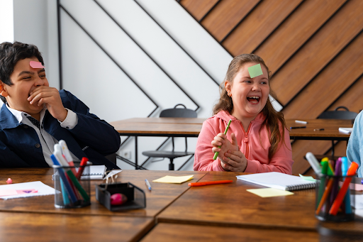 Happy kids playing with colourful sticky notes.